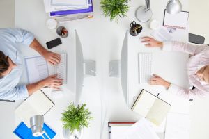 Overhead View Of Businesspeople Working At Office Computer